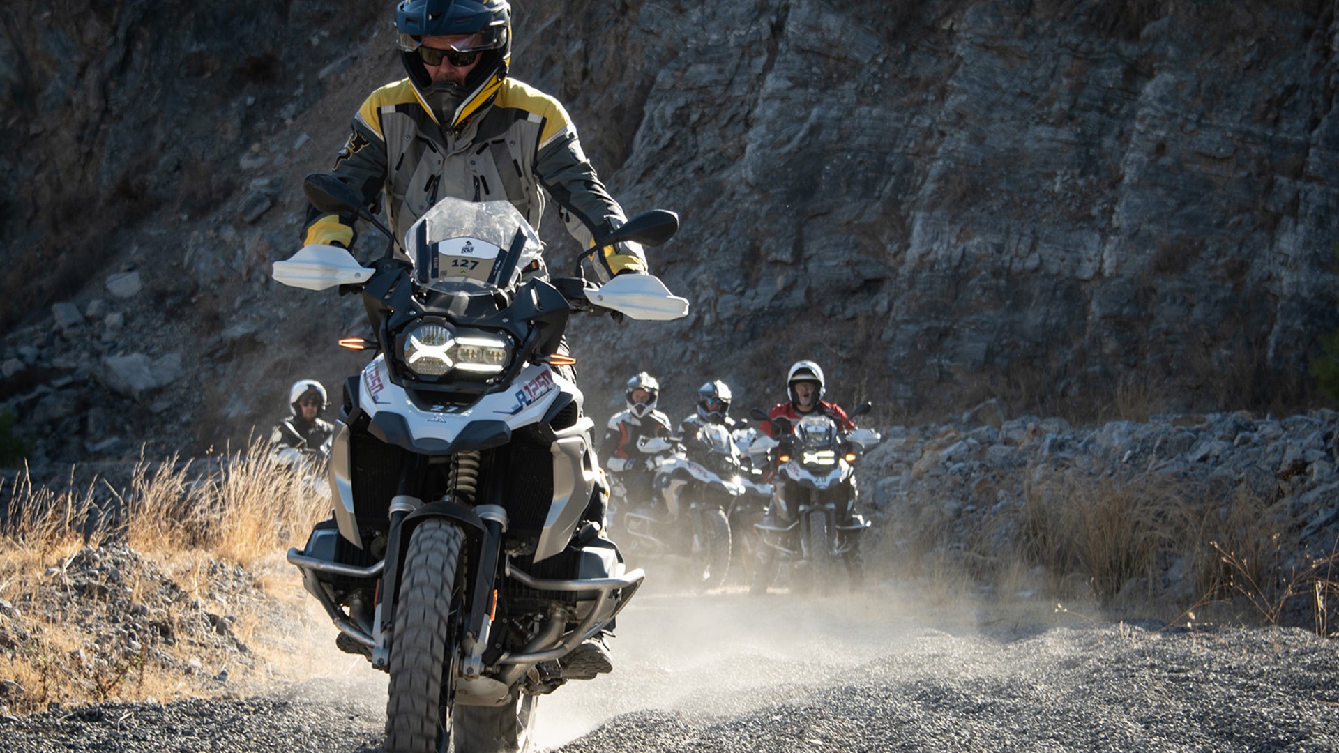 Participants ride on rugged terrain